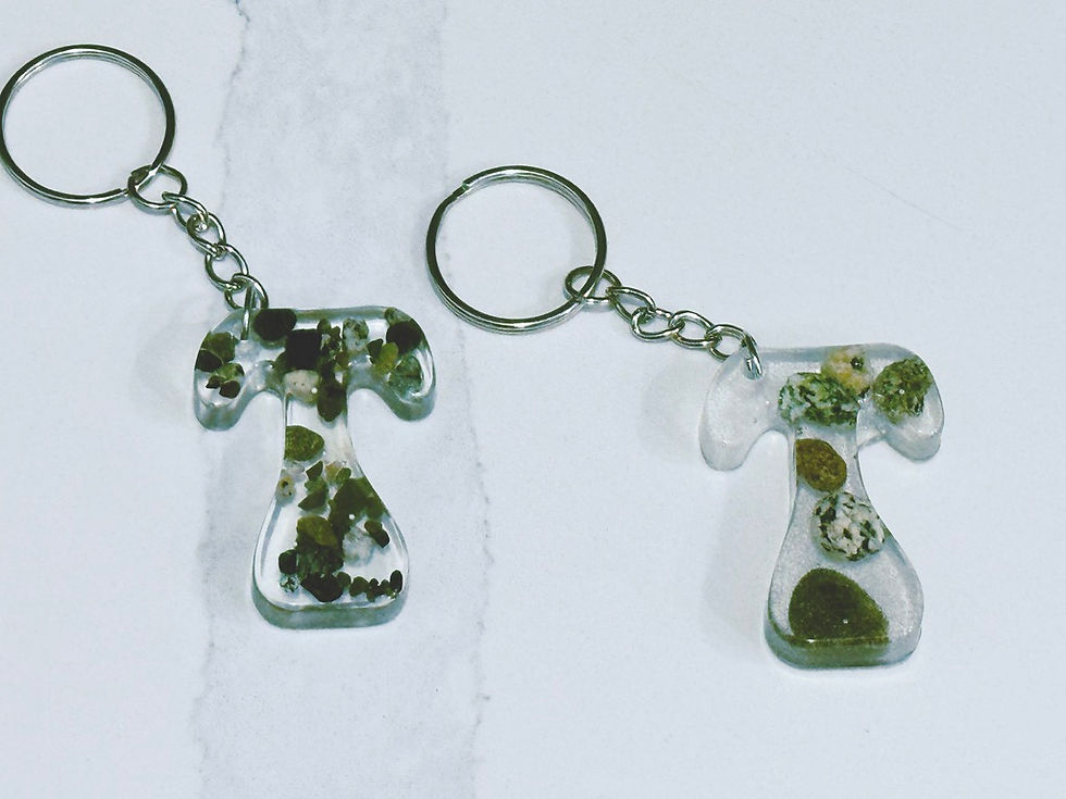 Thumbnail: Letter T epoxy resin keychain infused with broken beach pebbles
