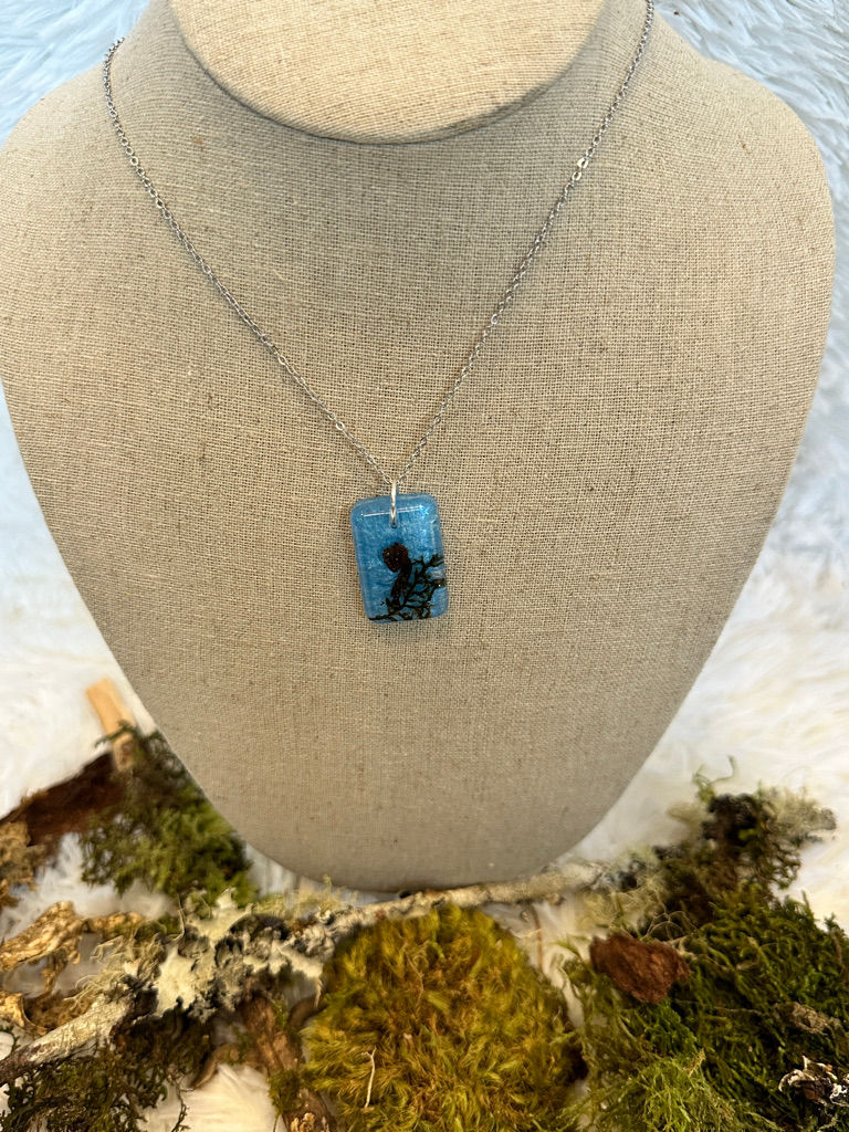 Thumbnail: Front view of blue rectangular necklace encased with real mushrooms and moss