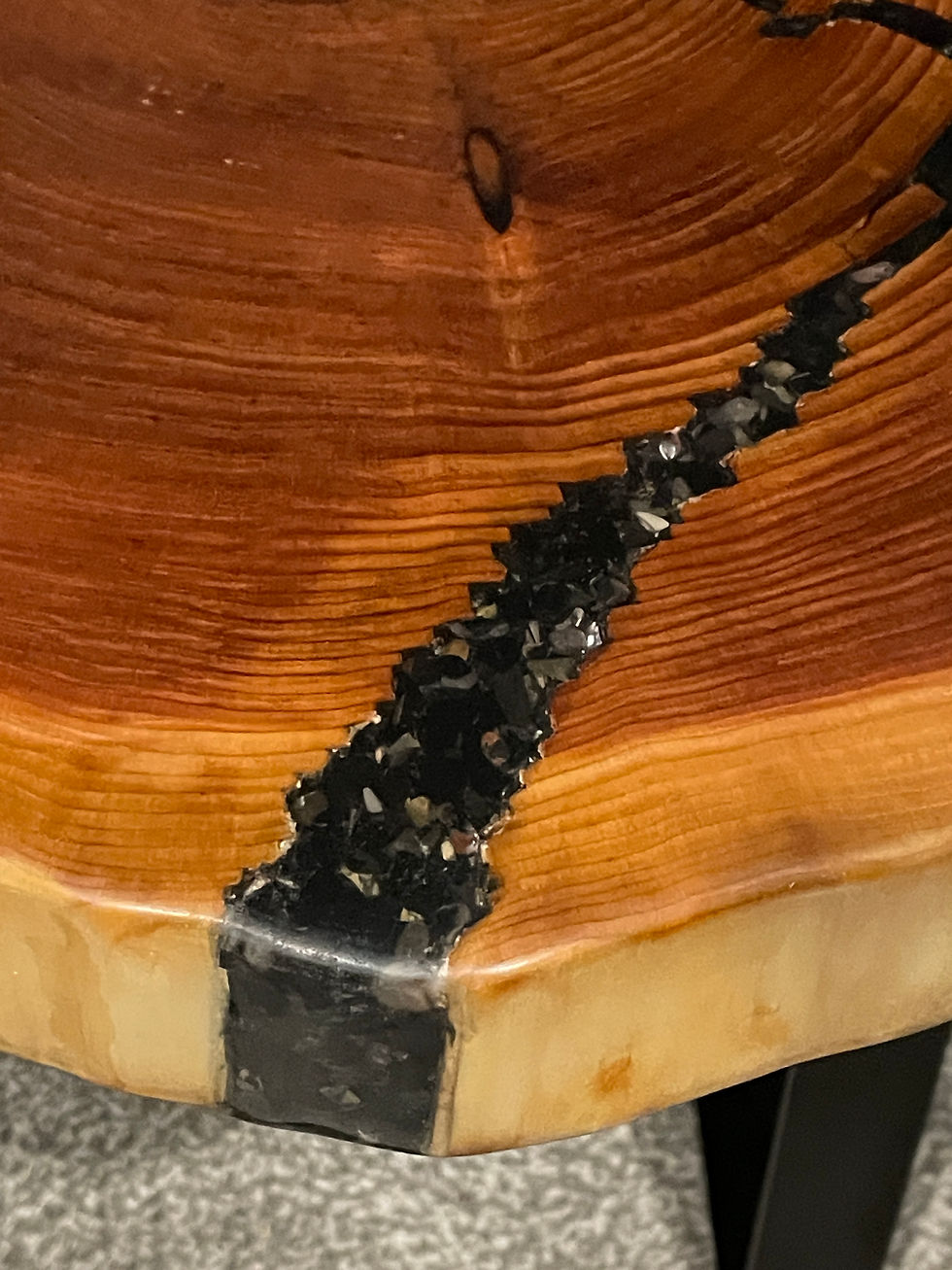 A red cedar end or side table with a river of black onyx gemstones in the crack