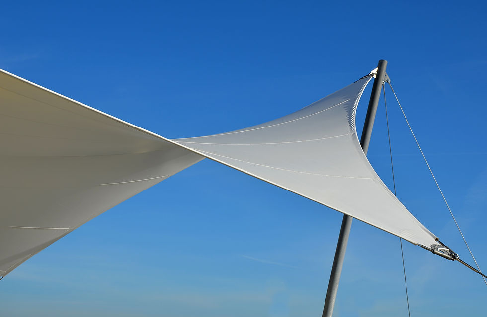 white tarpaulin taut, shading from the sun and rain over the terrace of the restaurant, on