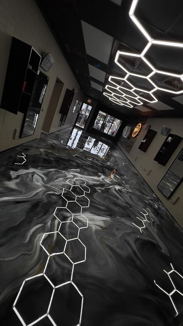 Custom metallic epoxy floor in a commercial shop