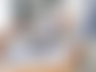 Two colleagues review engagement metrics and audience behavior data displayed on a laptop and surrounding printouts, emphasizing proactive monitoring and early intervention.