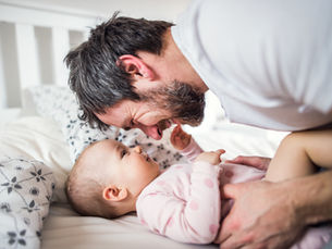 dad and baby smiling