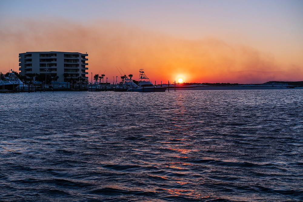 The sun sets over the Destin Harbor. Destin, Florida.
