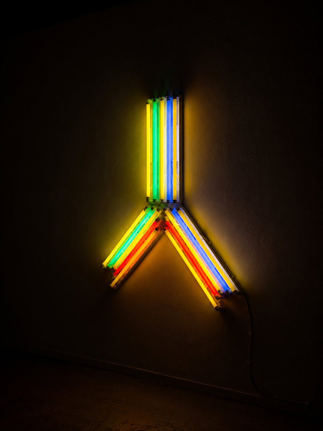 A fluorescent light installation of red, blue, yellow and red