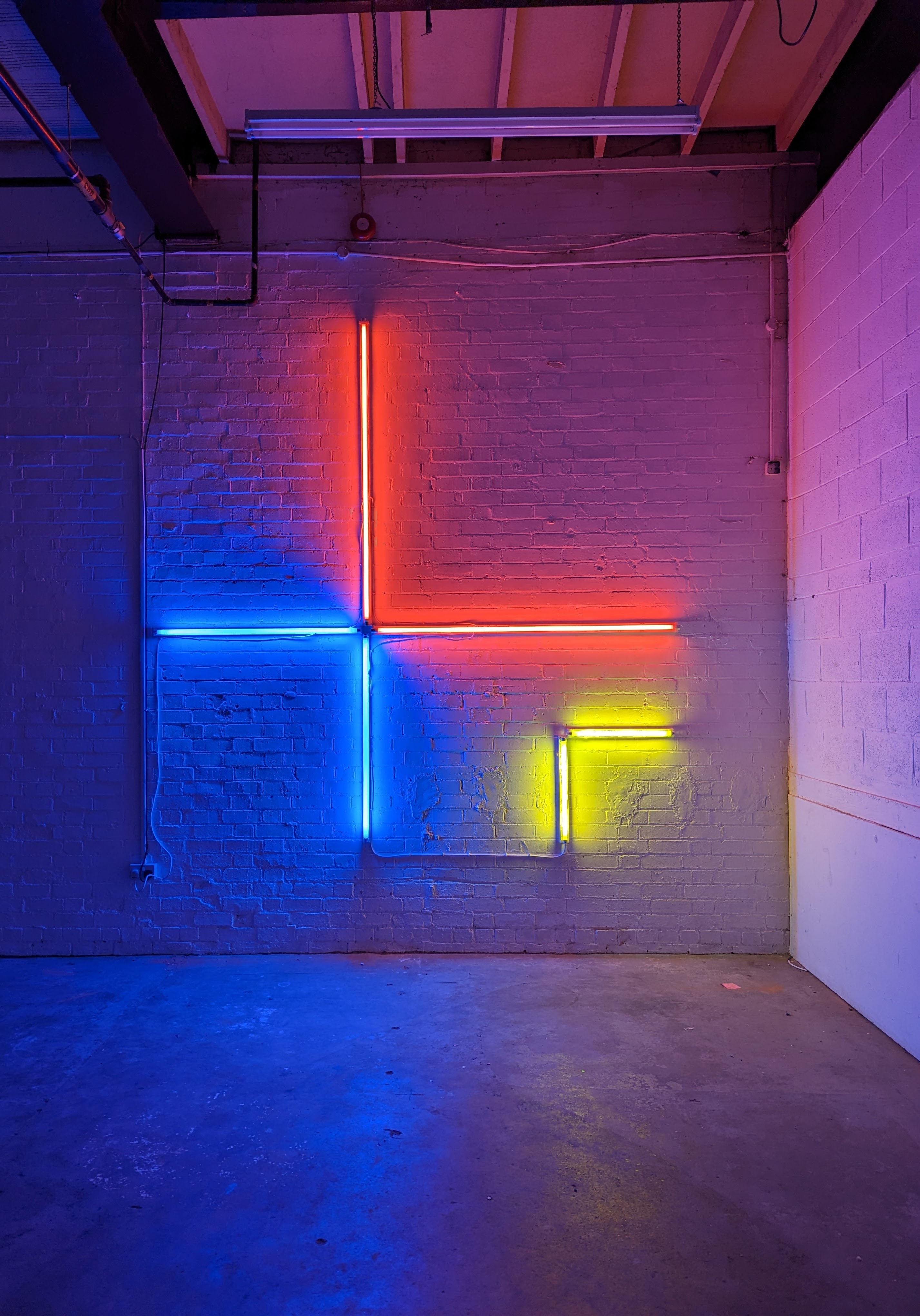 A large red, blue and yellow fluorescent light installation