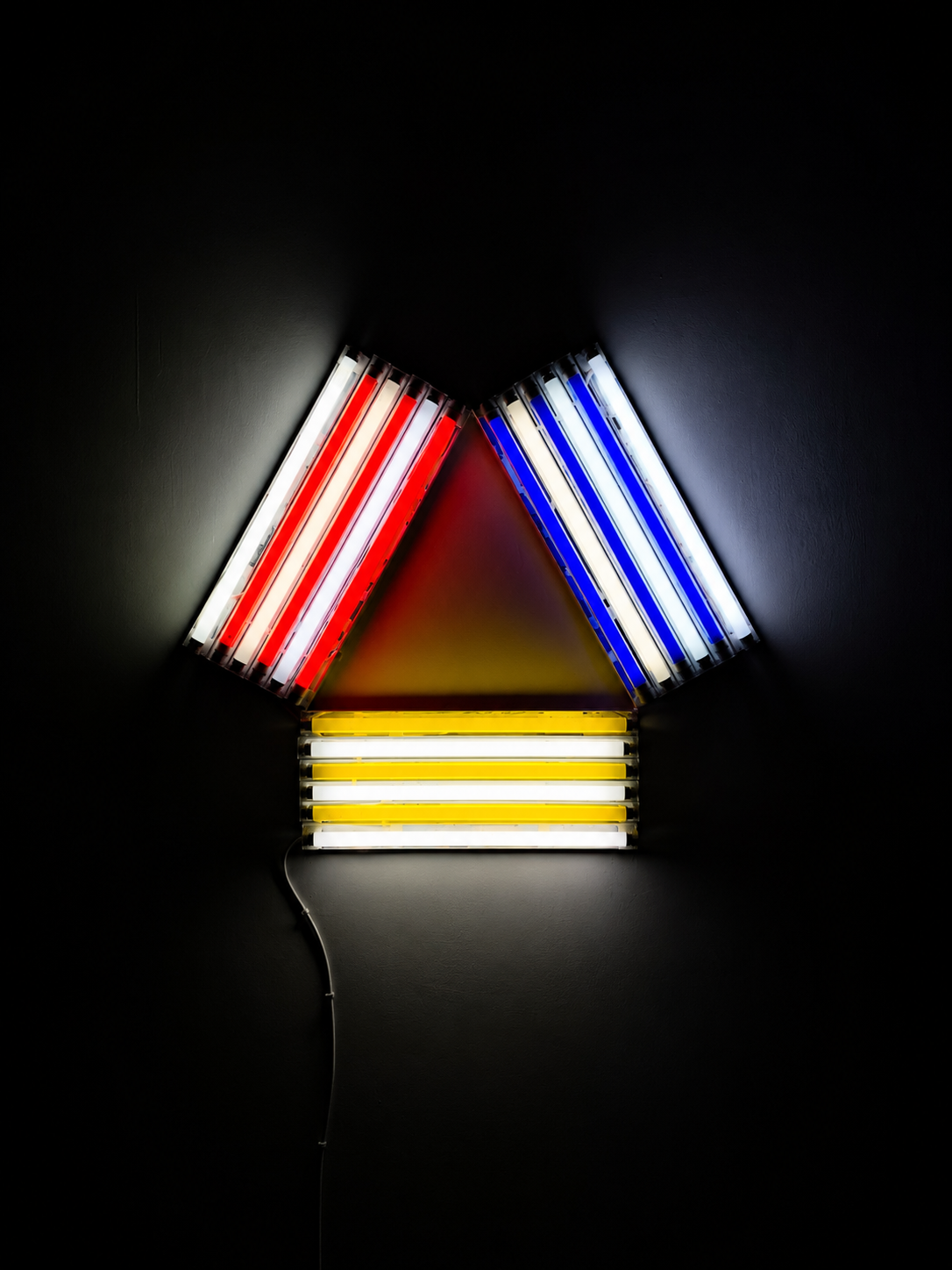 A fluorescent light installation of red, white, blue and yellow tubes