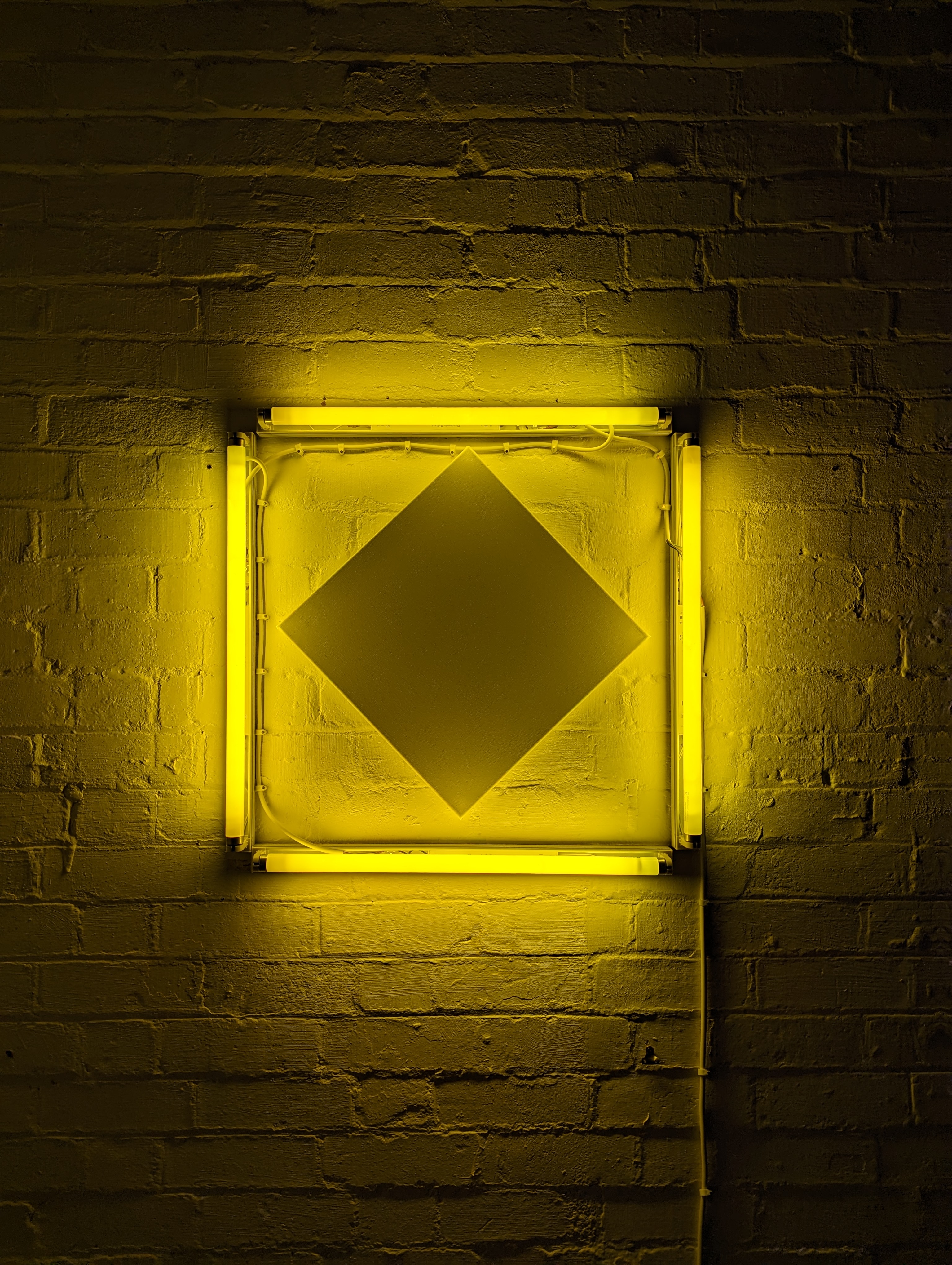 A white canvas inside four yellow fluorescent lines