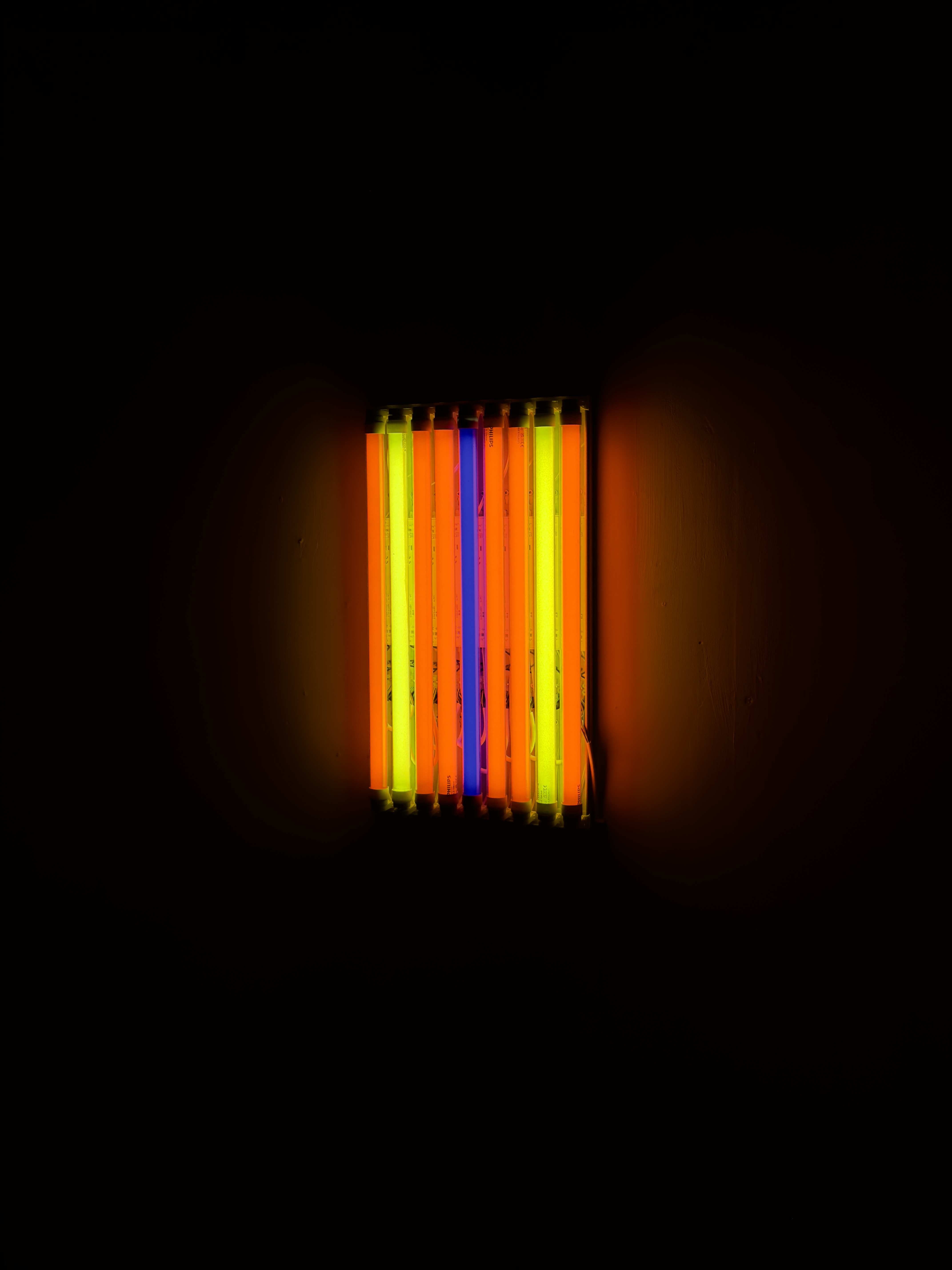 A row of fluorescent lights in red, yellow and blue, responding to the Barnett Newman painting 'Who's Afraid II'