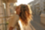 light relaxing image of girl in glasses close-up under sun's rays. Stands on balcony and