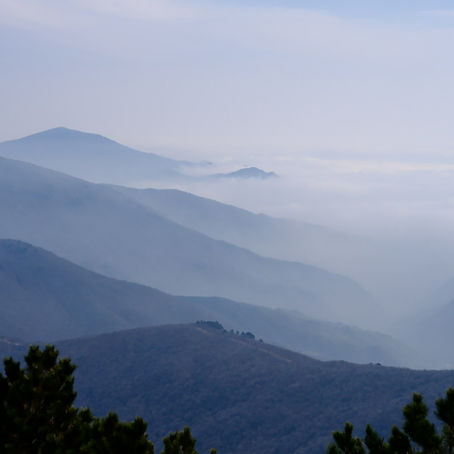 Mountains enshrouded in mist outlines visible