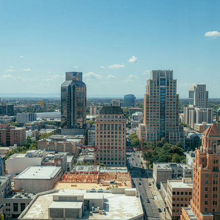 Mid sized city skyline with construction cranes