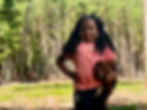 black farm camper holding chicken