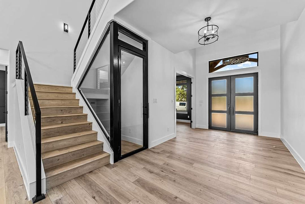 Custom steel stair stringer, railing and steel-framed glass door in a finished luxury home in Central Texas by JT Metalworks