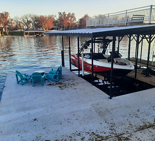 Completed custom steel boathouse with boat lift on Lake McQueeney and Lake Dunlap in Texas by JT Metalworks