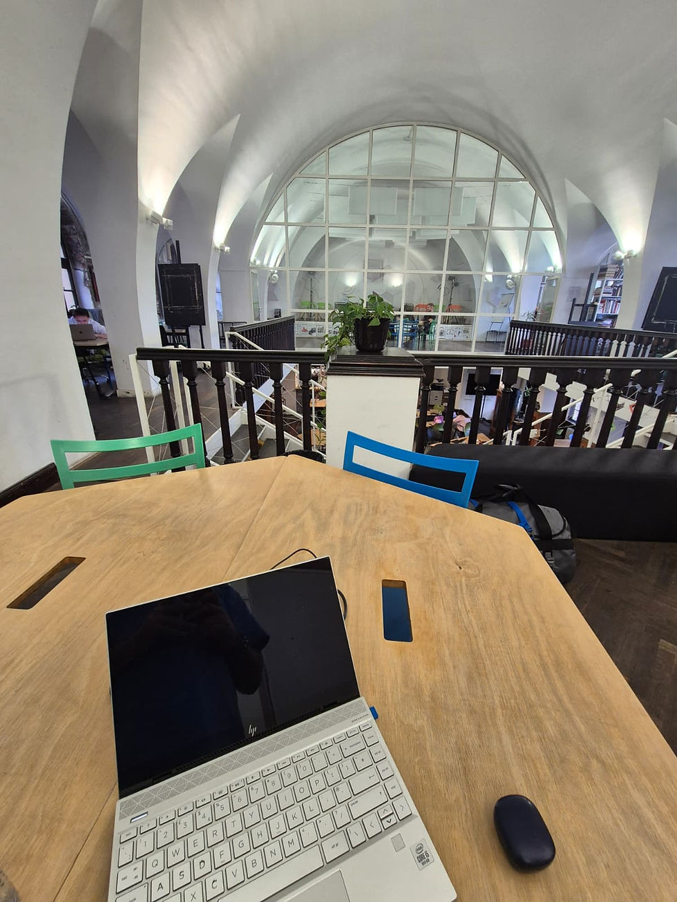 A table at Impact Hub Belgrade with a laptop on top