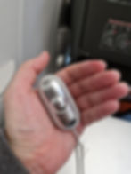 A CalmCarry device in a person's hand on an airplane.