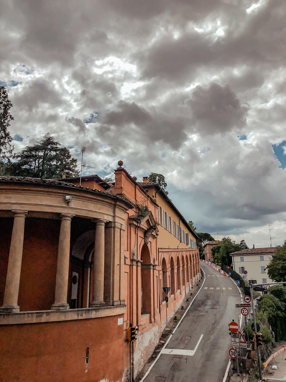 View from the start of the walk to San Luca. A cloudy sky forms the backdrop to Bologna's famous porticoes