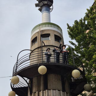 Three figures on the top of a tower in Lleida, Spain