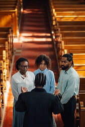 priest-speaking-with-family-in-church-after-sunday-2025-04-03-21-01-00-utc.jpg