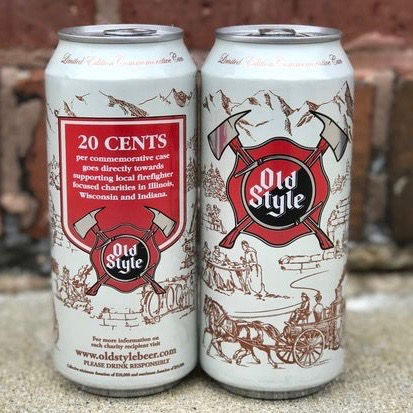 Two Old Style beer cans with a red and white design, featuring axes and a historical scene. Text mentions a charity donation per purchase.