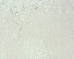 A sand dune in a desert with a beige sky