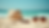 Eye-level view of a stylish beach hat and sunglasses on a sandy beach