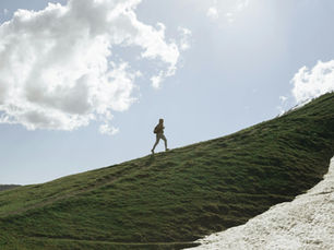 A hiker climbs a mountain