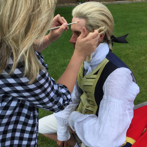 makeup artist in training glueing a wig down