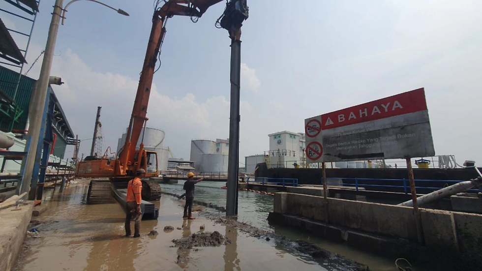 Vinyl sheet pile installation using an excavator-mounted vibratory hammer