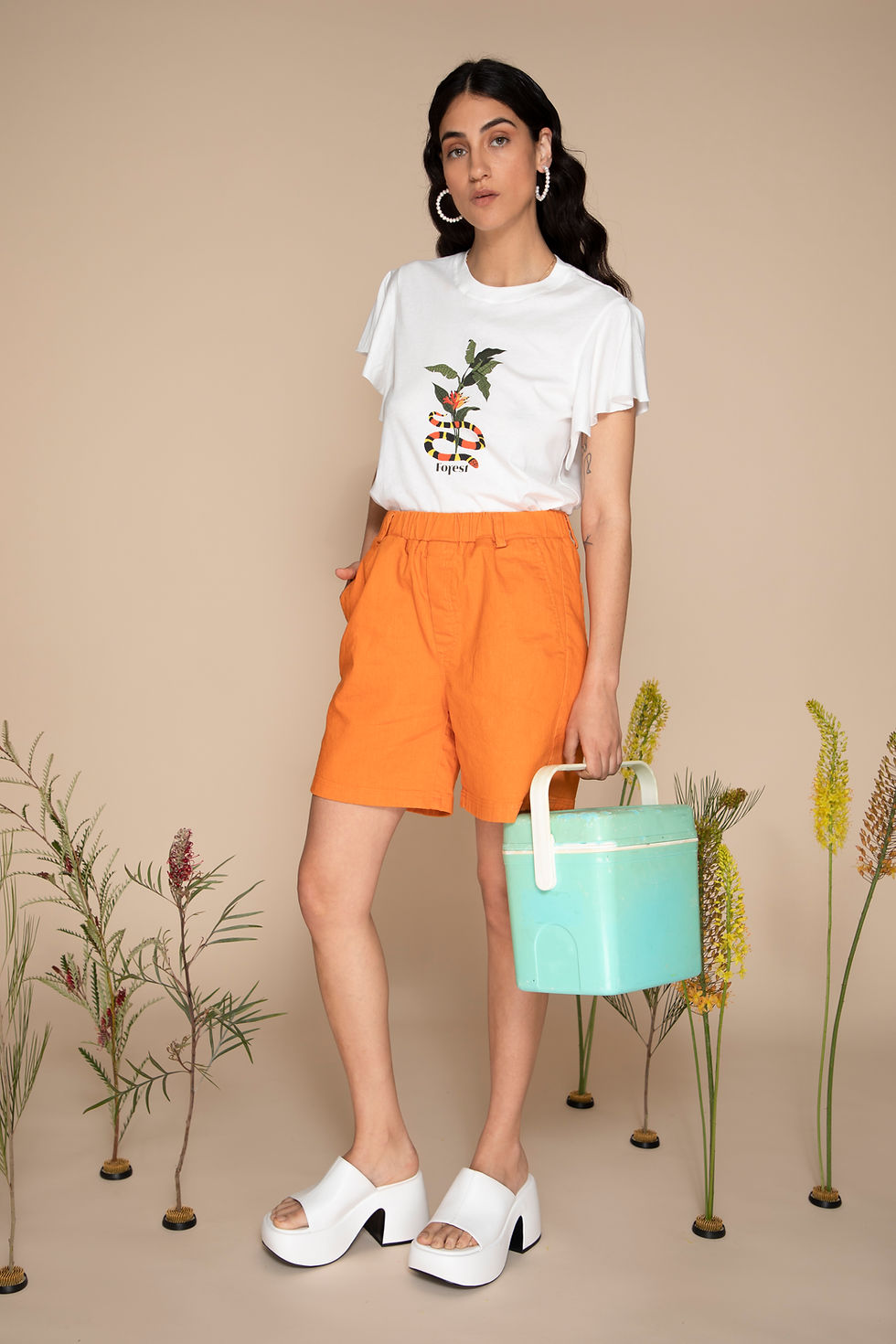 Thumbnail: Eden top from the front with orange shorts.