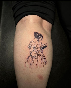 A charming black-and-white tattoo on the thigh depicting a Victorian-era woman reading a book, beautifully inked by a talented tattoo artist at the best tattoo shop in Lubbock.