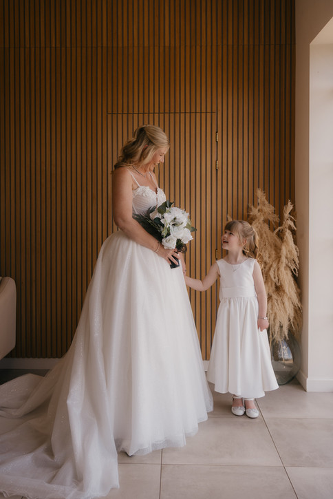 bride holding hands with daughter, devon wedding photographer upton barn
