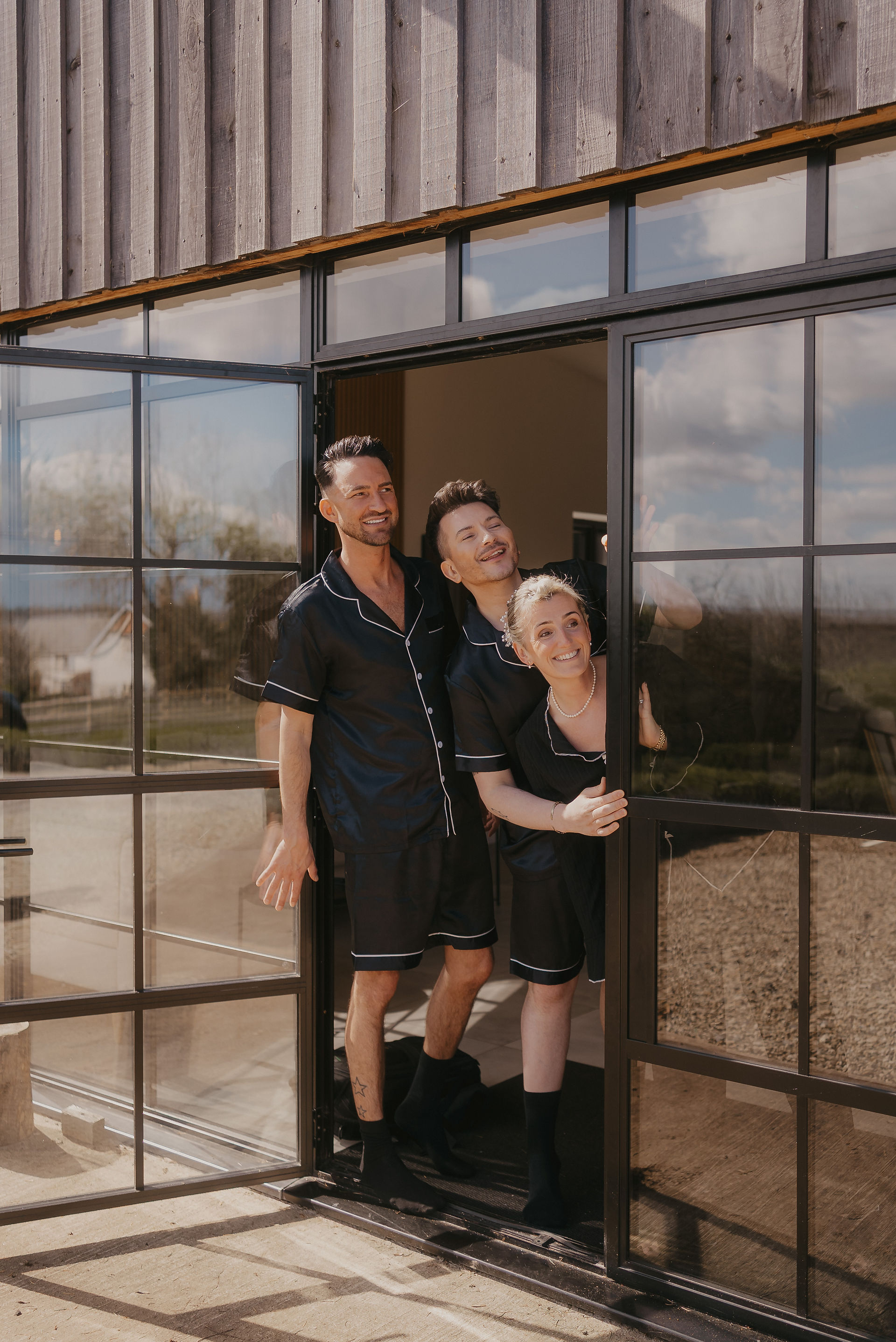 bridesmaids looking out window at the paddock at upton barn wedding venue in devon