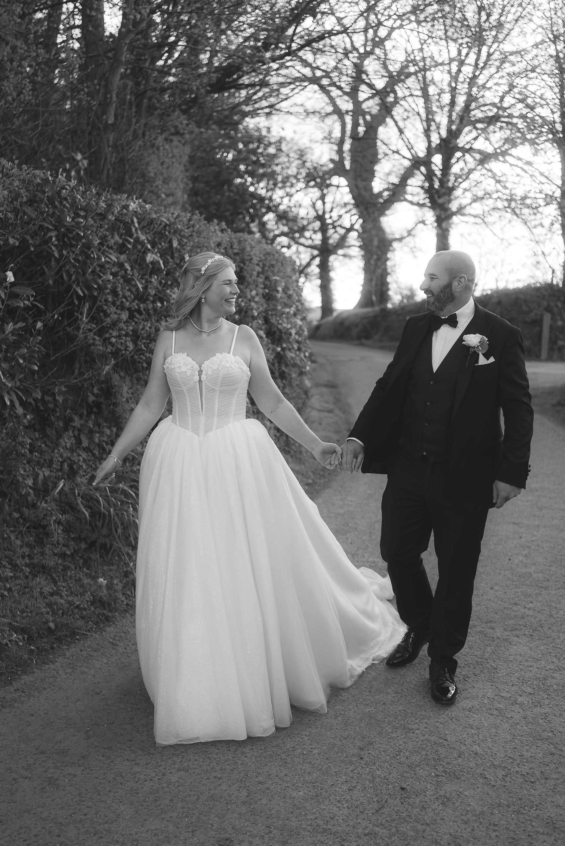 spring wedding, bride and groom walking holding hands at upton barn, devon