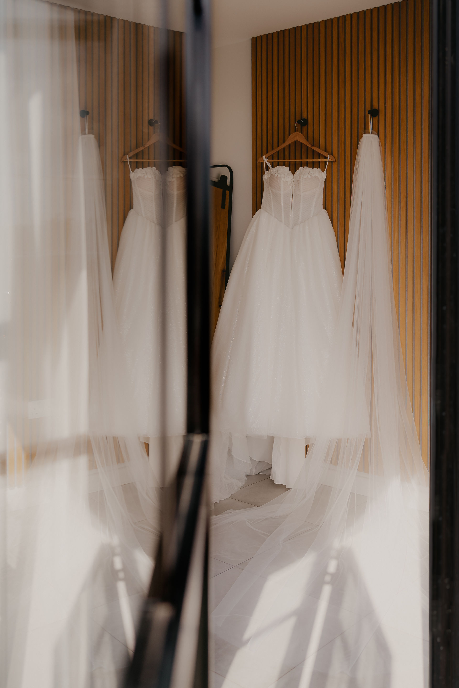 wedding dress hanging in paddock at Upton barn, devon wedding photography