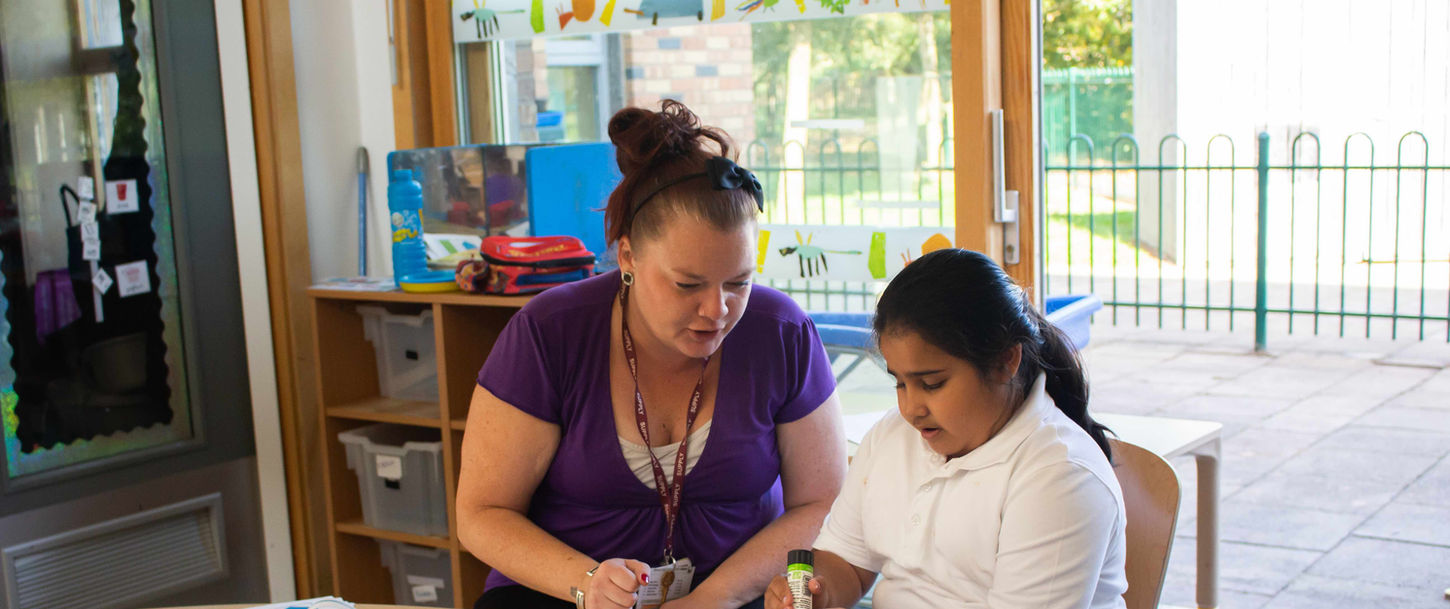 Staff member supporting child