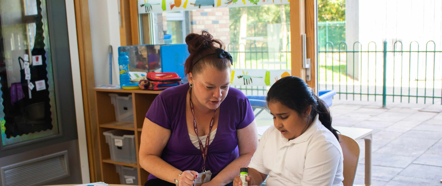 Staff member supporting child