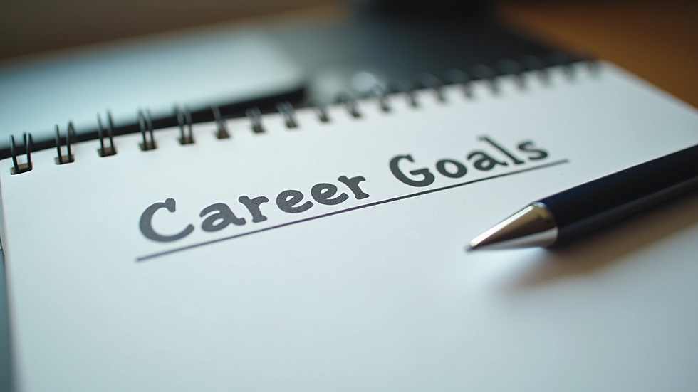 Close-up view of a notebook with career goals and a pen on a desk