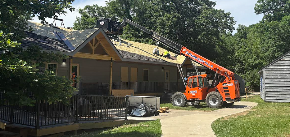 Image of Volunteers Working on Restoring the Roof of Cabins