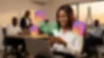 A young Nigerian woman in a co-working space smiles broadly while looking at her phone, with a large floating Instagram logo and a digital Dollar commission earned notification of $250 visible.
