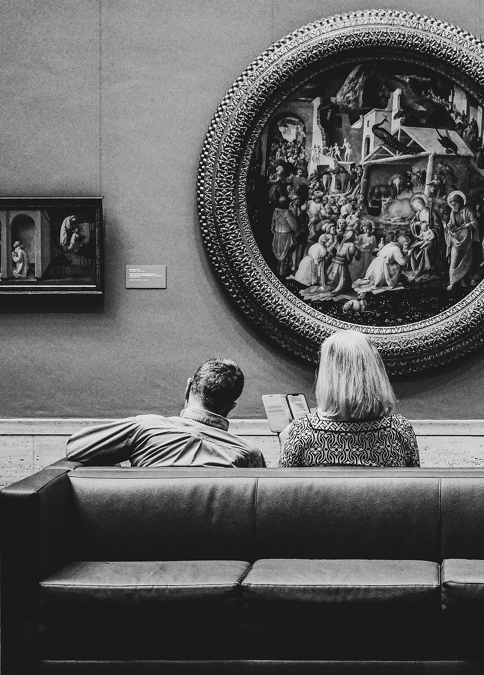 Visitors seated in an art gallery