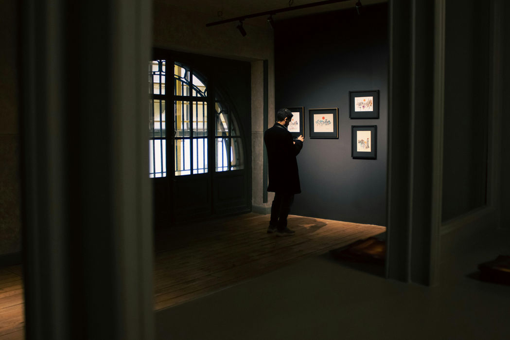 Gallery visitor observing artwork