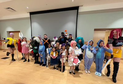 A wide picture of many individuals in various colorful cosplays.