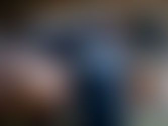 A man pats a brown horse, checking it for injuries.