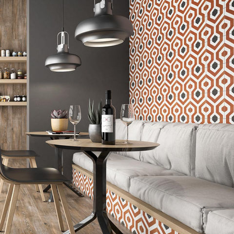 orange and black geometric patterned decorative tiles on a wall in a kitchen cafe