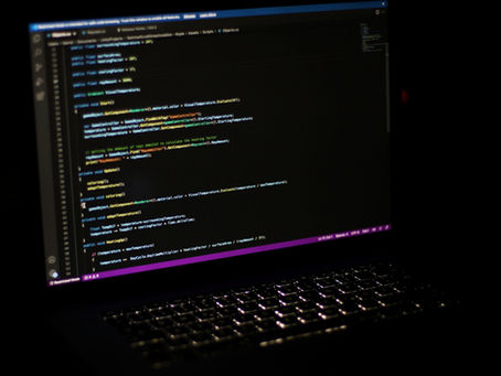 A laptop screen displaying lines of code.