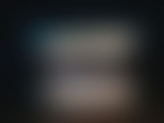 A laptop opening in the dark with a cityscape background (decoration)