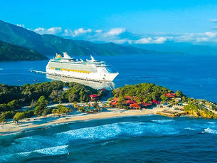 A Royal Caribbean cruise ship docked at Labadee, Haiti, a private resort with beaches and mountainous terrain.