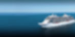 White Regant Seven Seas Explorer cruise ship sailing on a blue ocean under a clear sky.
